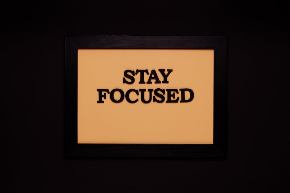 Minimalist black frame with 'Stay Focused' text on beige background.